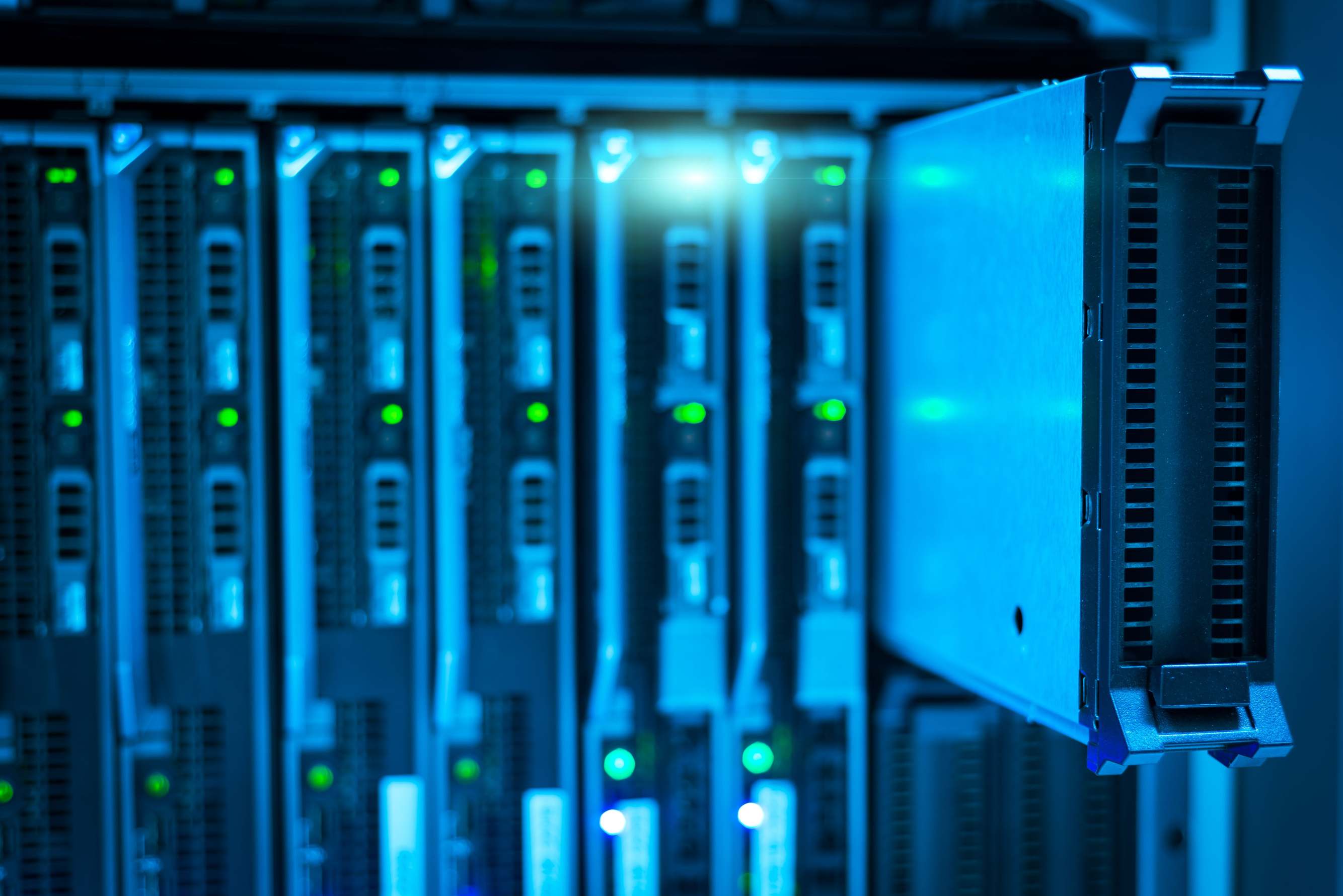 Rows of servers in a data centre corridor with network technology
